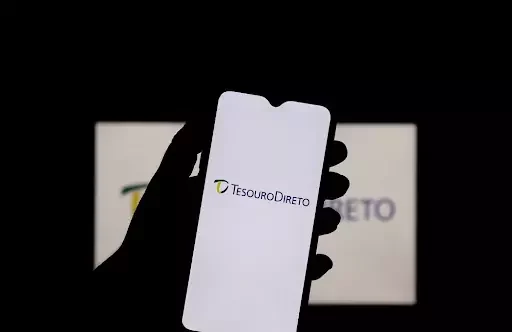 Celular com "Tesouro Direto" escrito na tela